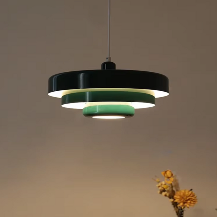 Bauhaus Metal LED Pendant Light in vibrant orange, green, and white with three-tier design illuminating a modern room.