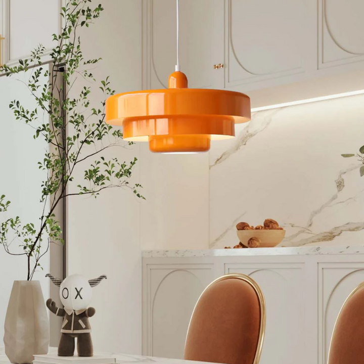 Bauhaus Metal LED Pendant Light in vibrant orange, green, and white with three-tier design illuminating a modern room.
