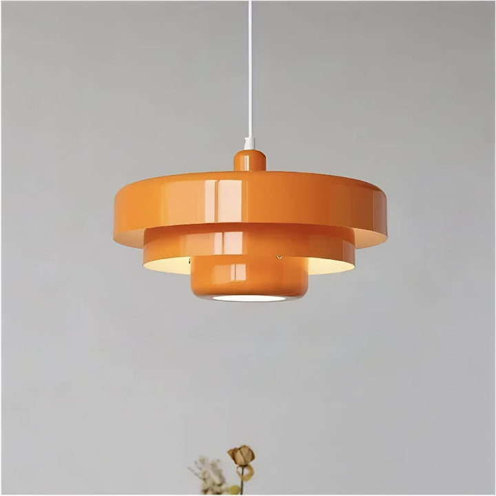 Bauhaus Metal LED Pendant Light in vibrant orange, green, and white with three-tier design illuminating a modern room.