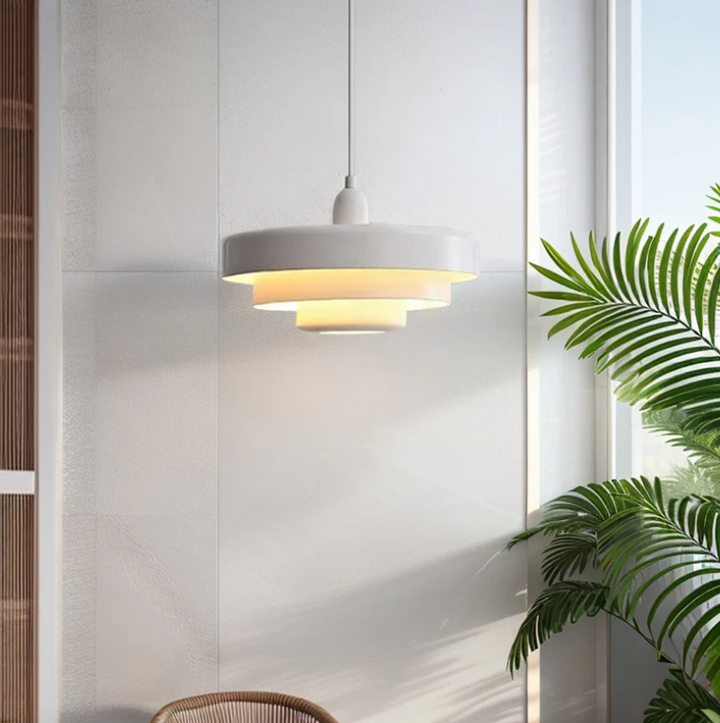 Bauhaus Metal LED Pendant Light in vibrant orange, green, and white with three-tier design illuminating a modern room.