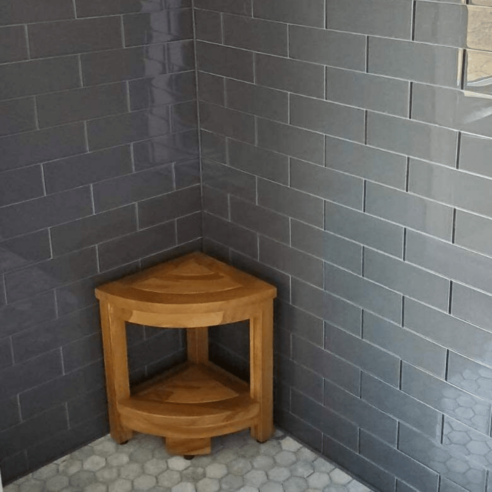"Compact premium teak wood shower corner bench seat with lower shelf, durable water-resistant construction for bathroom use."