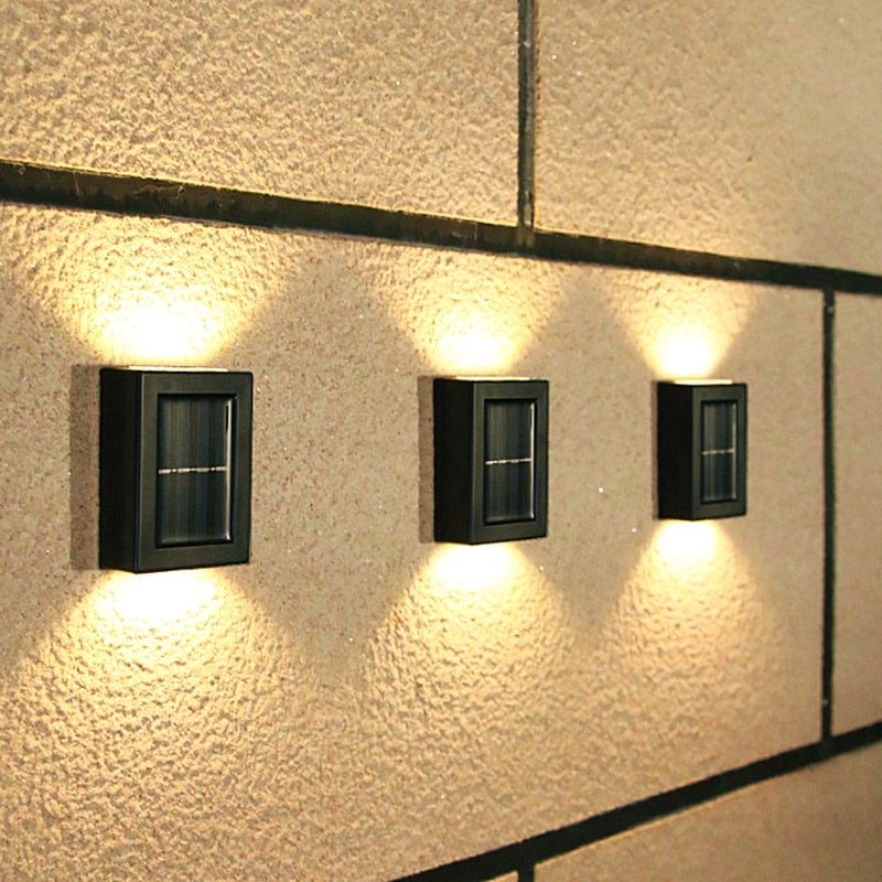 "Eco-friendly solar wall light illuminating garden fence at night; warm white LED, sleek, modern outdoor lighting."