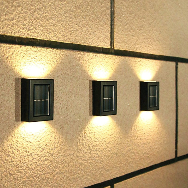 "Eco-friendly solar wall light illuminating garden fence at night; warm white LED, sleek, modern outdoor lighting."