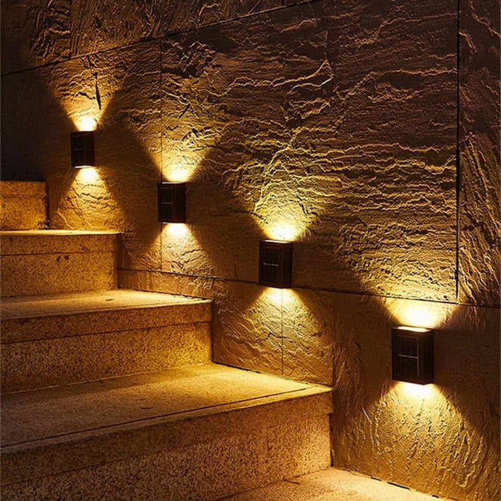 "Eco-friendly solar wall light illuminating garden fence at night; warm white LED, sleek, modern outdoor lighting."