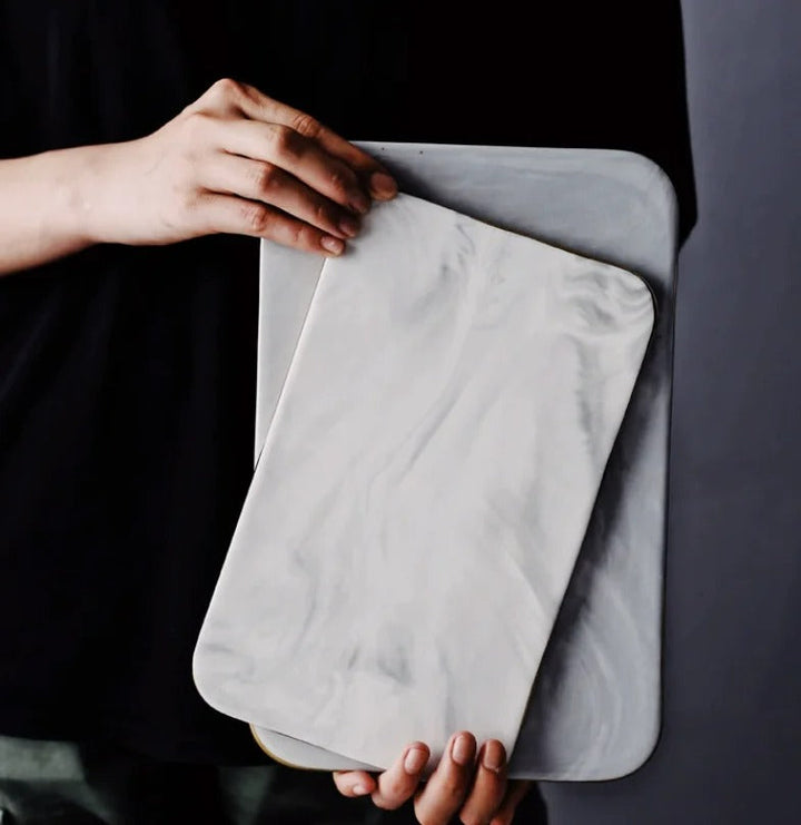 Elegant marble cutting board with smooth, luxurious surface for gourmet cooking, perfect for slicing and artistic serving.