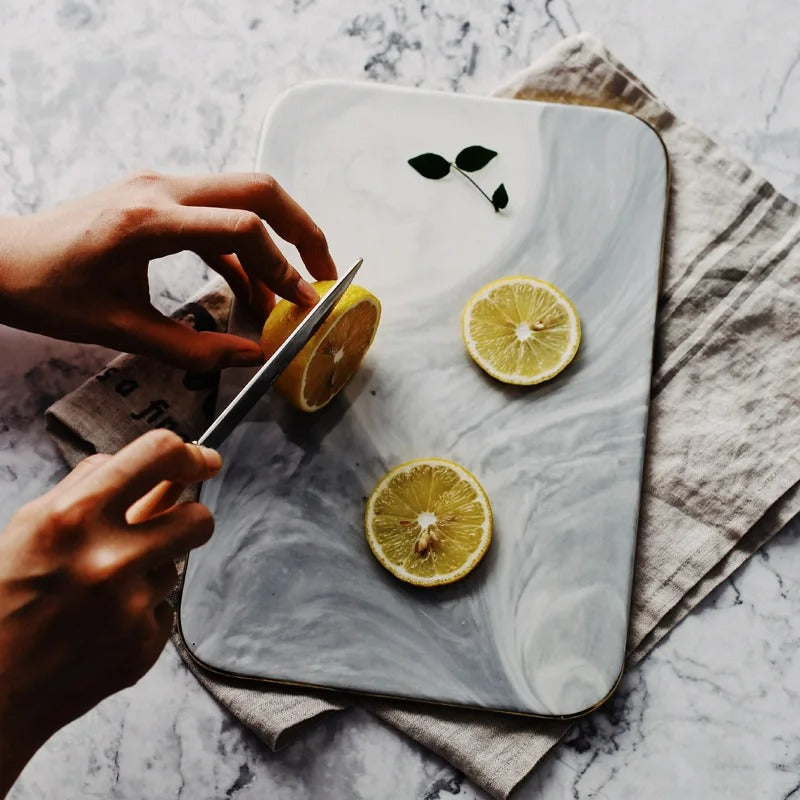 Elegant marble cutting board with smooth, luxurious surface for gourmet cooking, perfect for slicing and artistic serving.