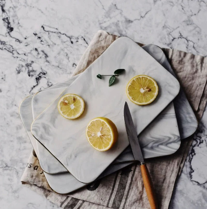 Elegant marble cutting board with smooth, luxurious surface for gourmet cooking, perfect for slicing and artistic serving.