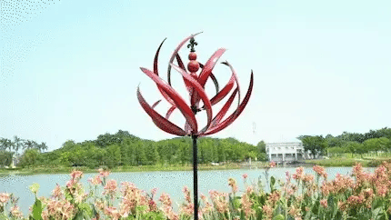 Elegant metal wind spinner for garden, showing smooth rotation and vibrant red and blue colors, enhancing outdoor decor.