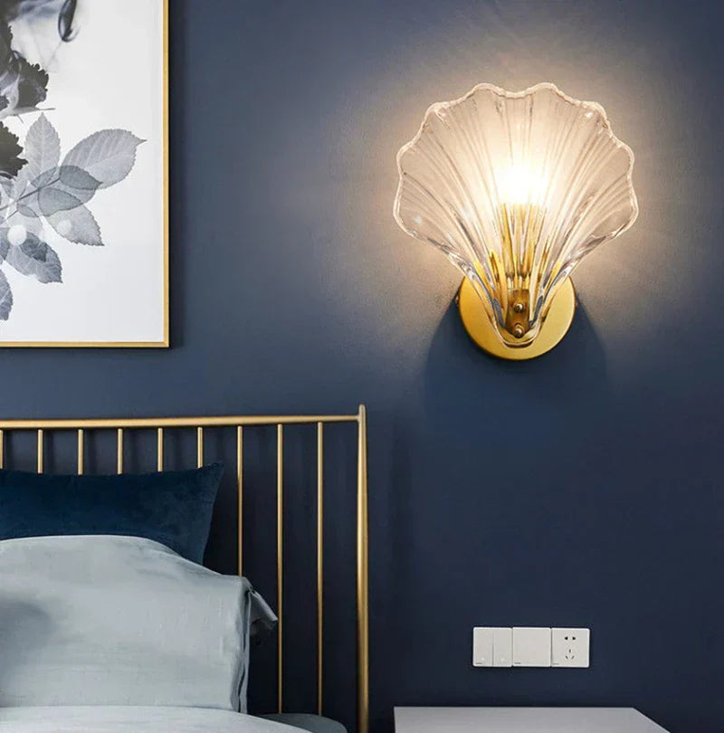 "Elegant shell-shaped wall sconce with warm LED glow, crafted from glass, enhances decor with seaside charm for home lighting