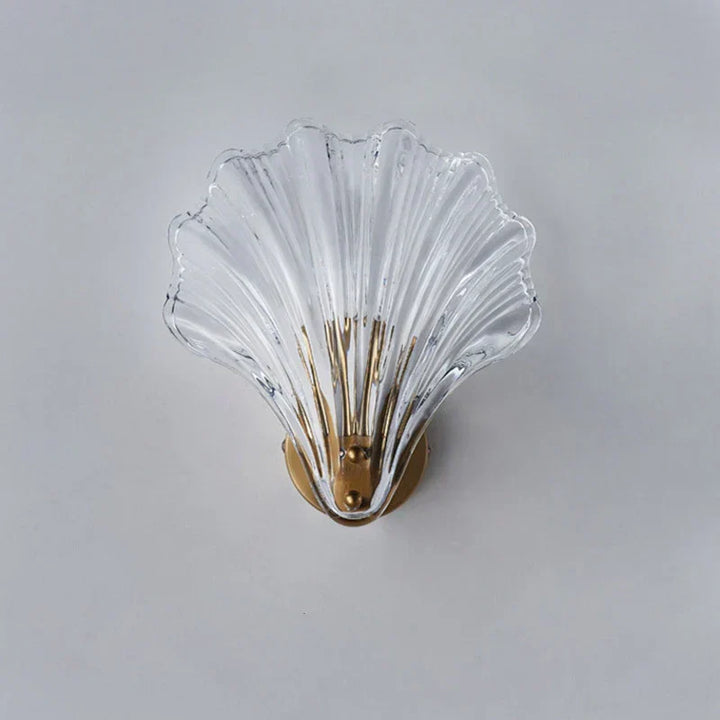 "Elegant shell-shaped wall sconce with warm LED glow, crafted from glass, enhances decor with seaside charm for home lighting