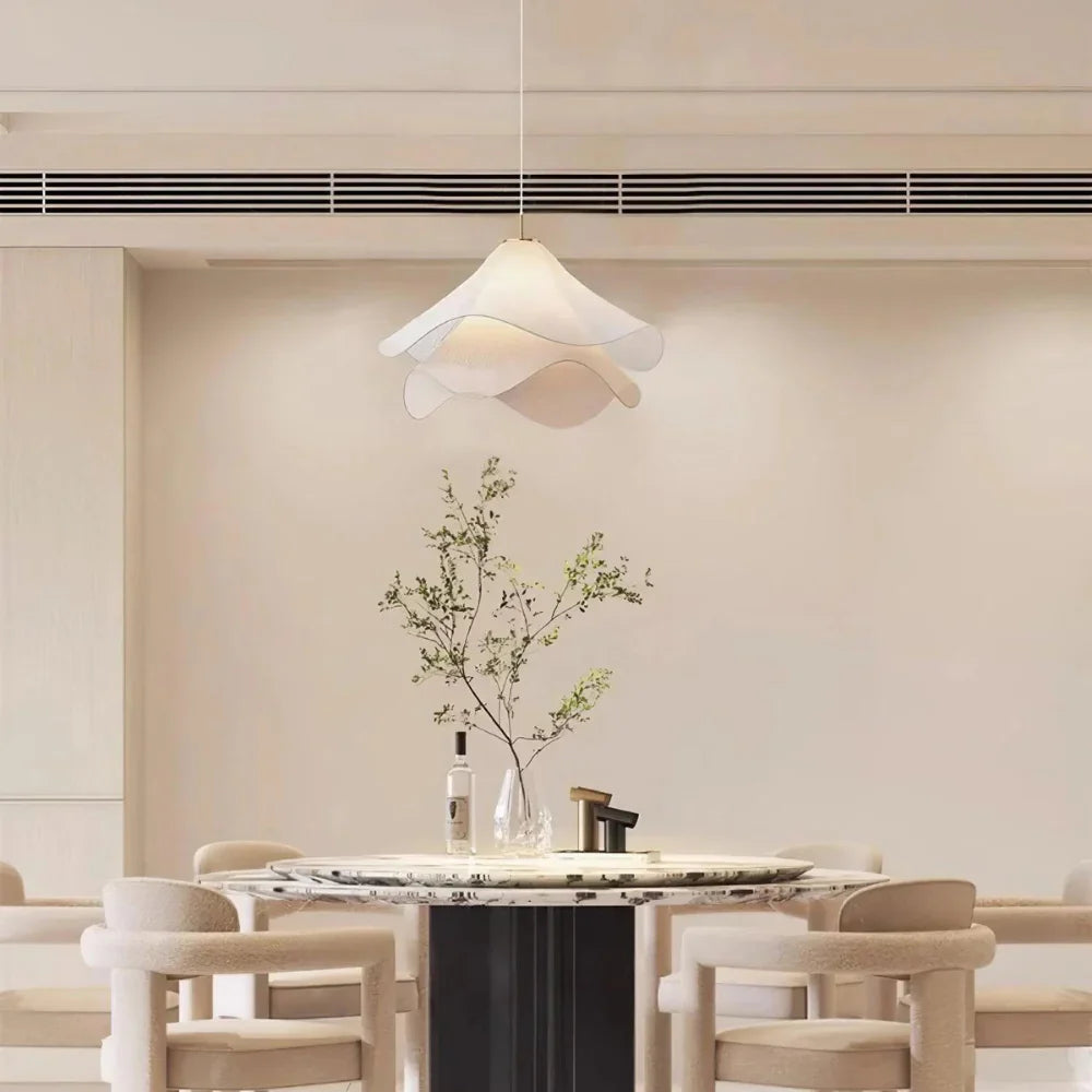 Elegant white fabric flower pendant light with soft LED glow, resembling delicate petals, perfect for modern interiors.