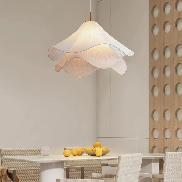 Elegant white fabric flower pendant light with soft LED glow, resembling delicate petals, perfect for modern interiors.
