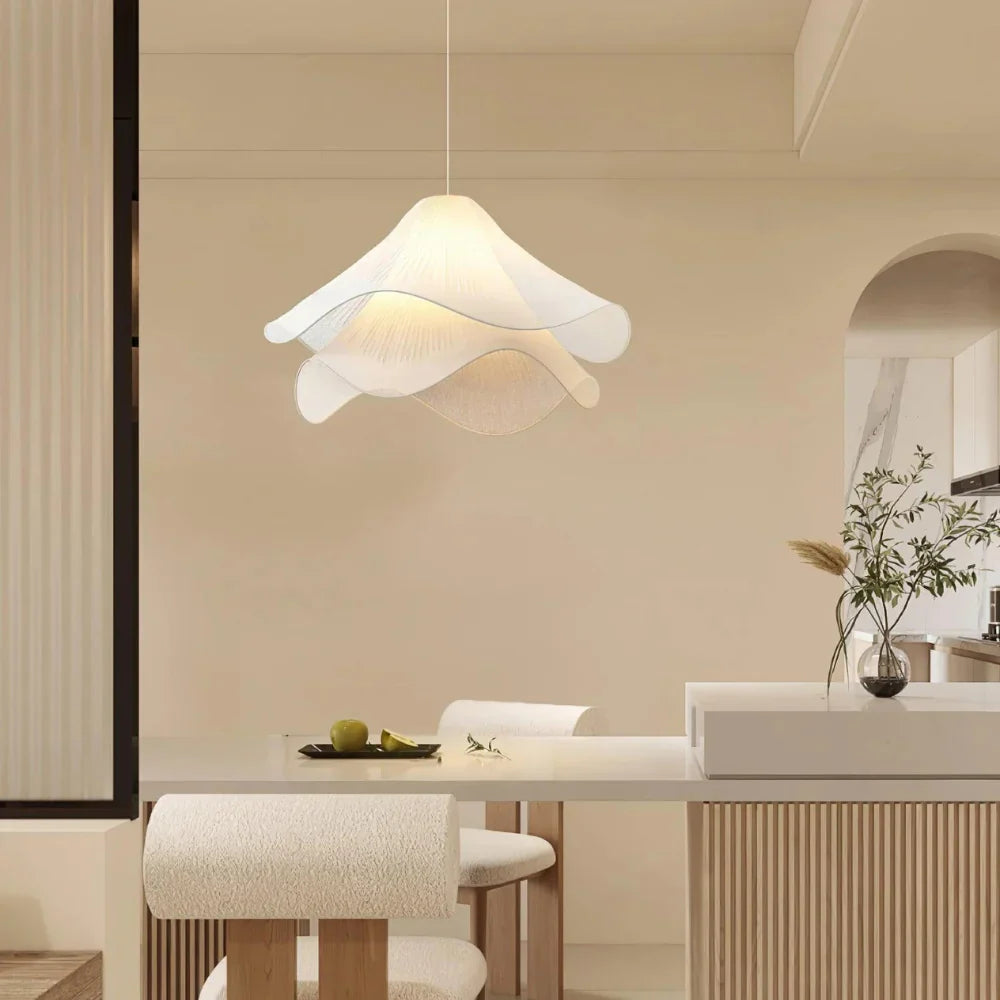 Elegant white fabric flower pendant light with soft LED glow, resembling delicate petals, perfect for modern interiors.