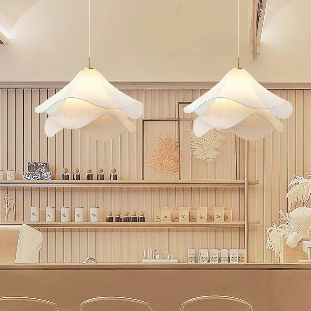 Elegant white fabric flower pendant light with soft LED glow, resembling delicate petals, perfect for modern interiors.