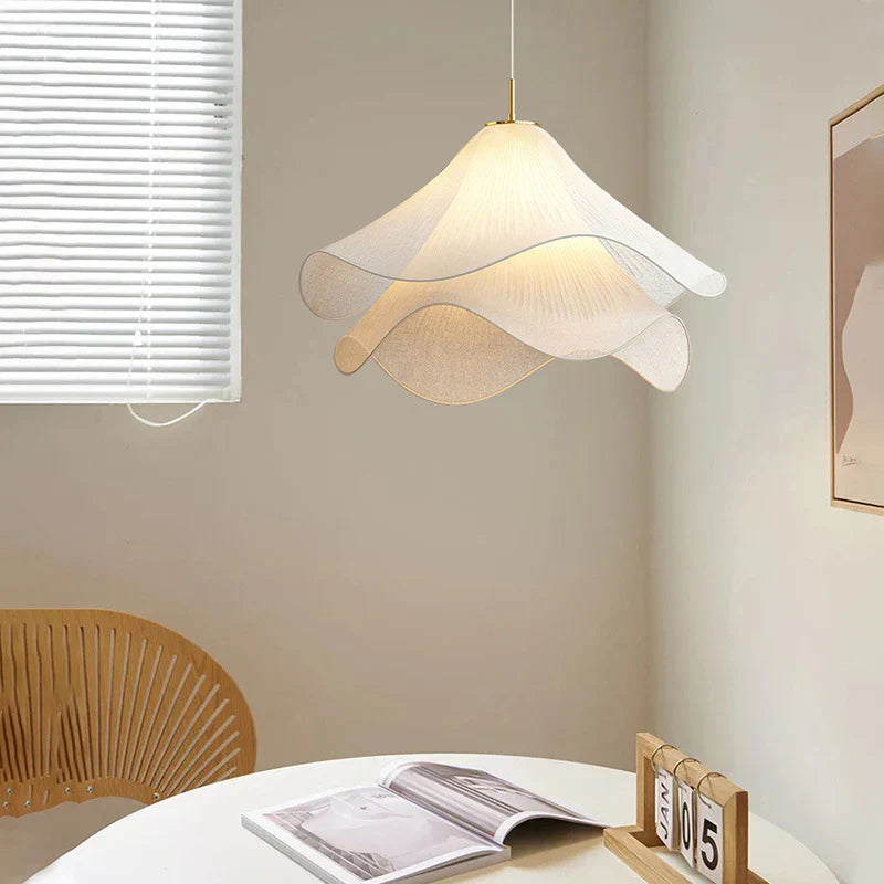 Elegant white fabric flower pendant light with soft LED glow, resembling delicate petals, perfect for modern interiors.