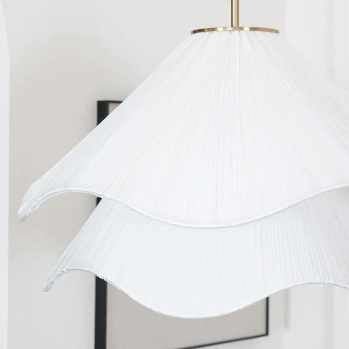 Elegant white fabric flower pendant light with soft LED glow, resembling delicate petals, perfect for modern interiors.