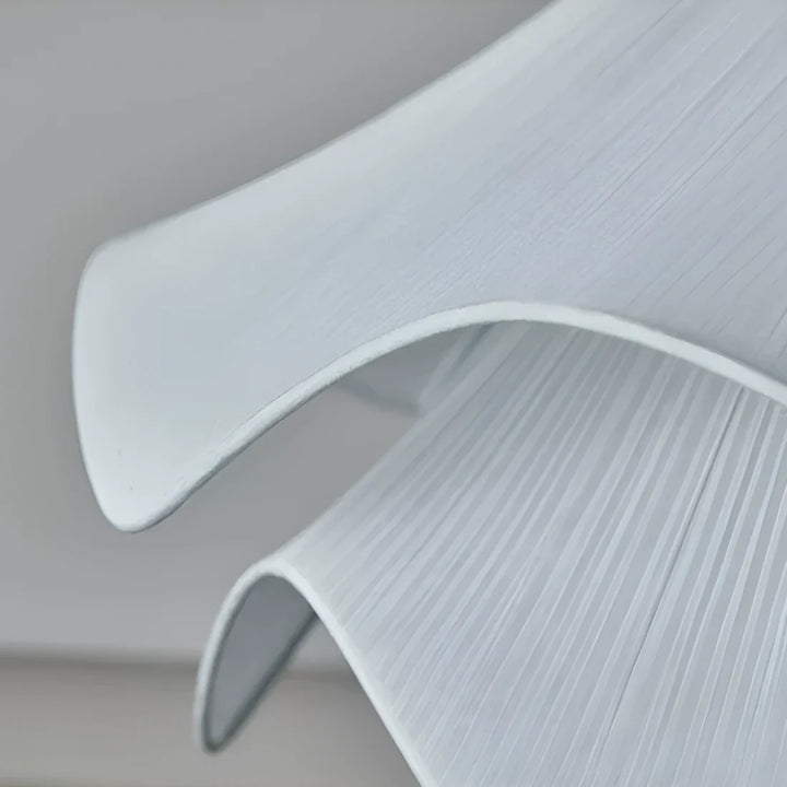Elegant white fabric flower pendant light with soft LED glow, resembling delicate petals, perfect for modern interiors.