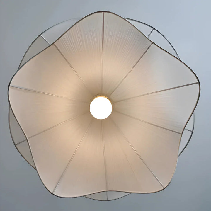 Elegant white fabric flower pendant light with soft LED glow, resembling delicate petals, perfect for modern interiors.