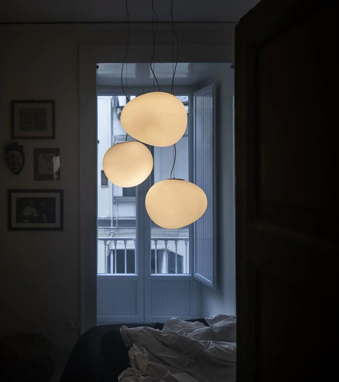 Elegant white glass globe pendant ceiling light with sleek design, ideal for modern decor, enhances dining rooms and lounges.