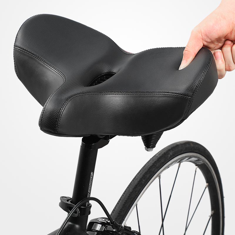 Extra wide cushioned bicycle seat with ergonomic design, shock-absorbing springs, breathable material, and universal fit.