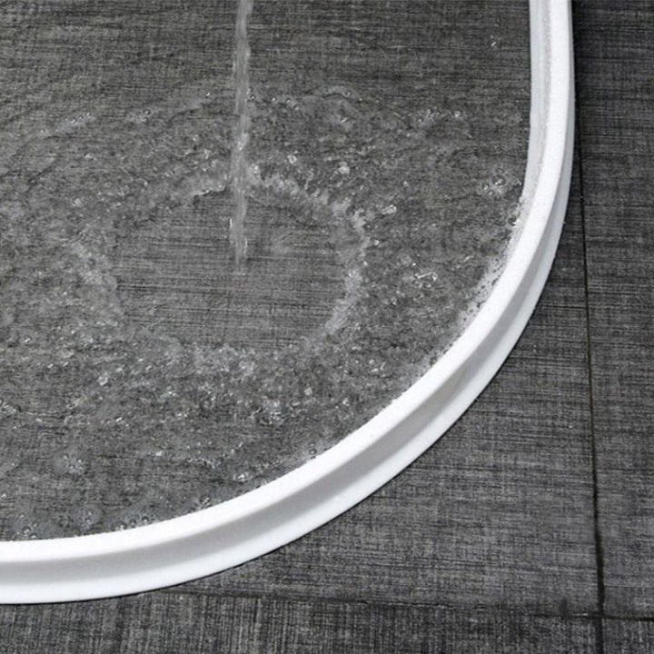 Flexible silicone shower barrier for leakproof seal, keeping bathroom dry. Bendable, self-adhesive strip for easy installatio