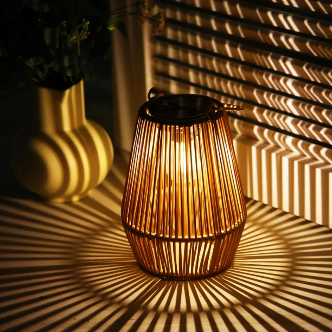 Handwoven solar lantern for gardens, featuring a brown rattan design, LED light, and eco-friendly solar-powered technology.