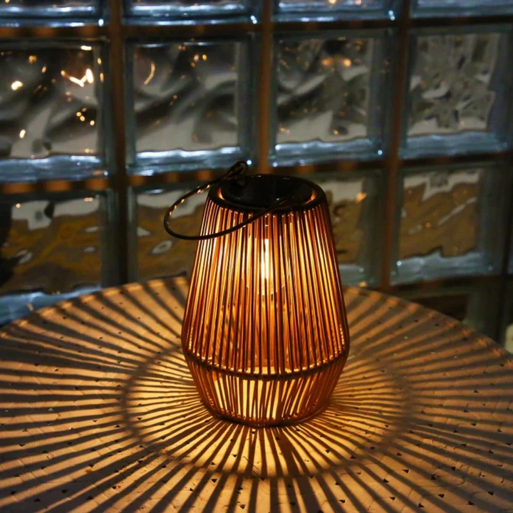 Handwoven solar lantern for gardens, featuring a brown rattan design, LED light, and eco-friendly solar-powered technology.