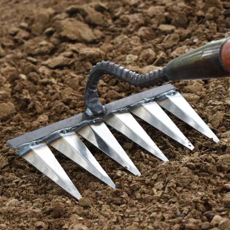 Heavy-duty stainless steel garden rake with deep-penetrating tines, ergonomic handle, and durable, rust-resistant design.