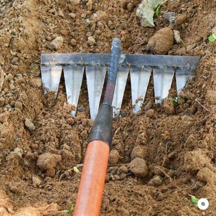 Heavy-duty stainless steel garden rake with deep-penetrating tines, ergonomic handle, and durable, rust-resistant design.