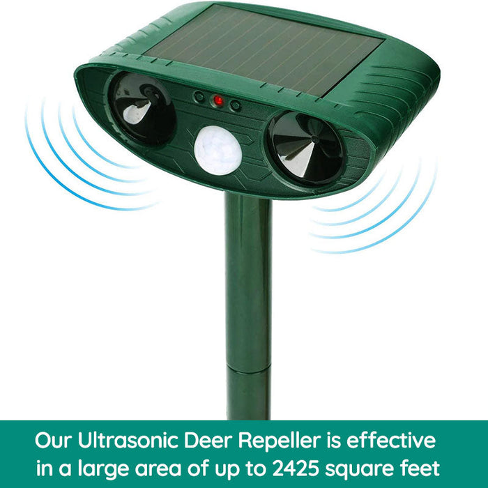 "Infrared solar animal pest repeller with ultrasonic technology in garden setting, solar panel atop a green weatherproof devi