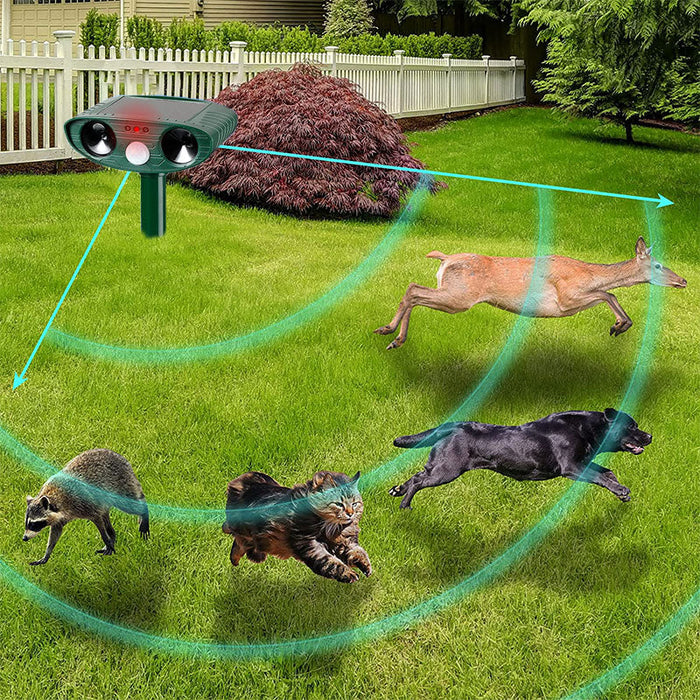 "Infrared solar animal pest repeller with ultrasonic technology in garden setting, solar panel atop a green weatherproof devi