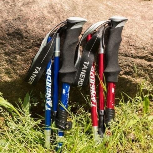 Lightweight foldable aluminium hiking poles with ergonomic EVA foam grips, ideal for trekking on various terrains.