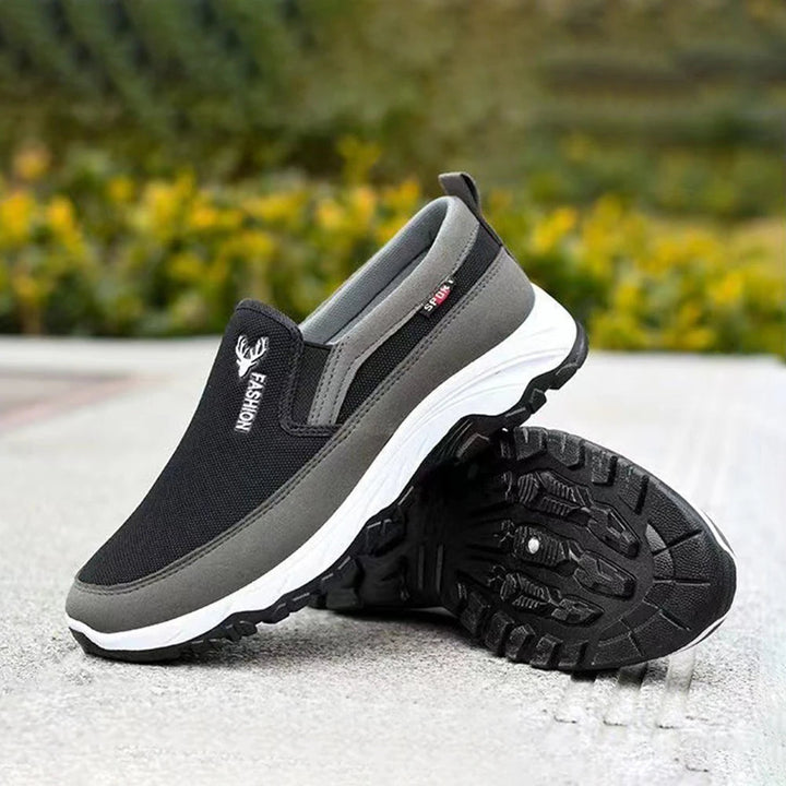 Men's cushioned slip-on walking shoes with breathable mesh, elastic panels, and grip outsole for comfort and stability.