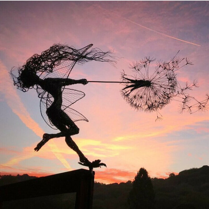 Metal fairy garden sculpture, weather-resistant, intricate design, black metal, adds whimsical charm to outdoor decor.