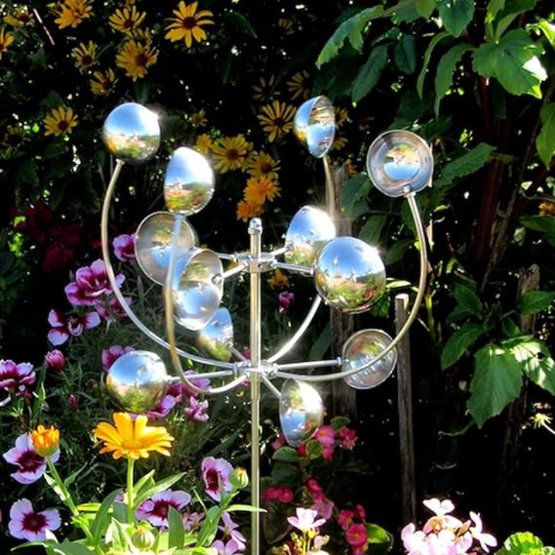 Metallic wind spinner with sleek design and reflective finish, spinning gracefully in a garden setting for outdoor elegance.