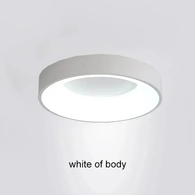 Modern circular LED ceiling light with sleek metal frame, soft ambient lighting; available in grey, white, wood finishes.