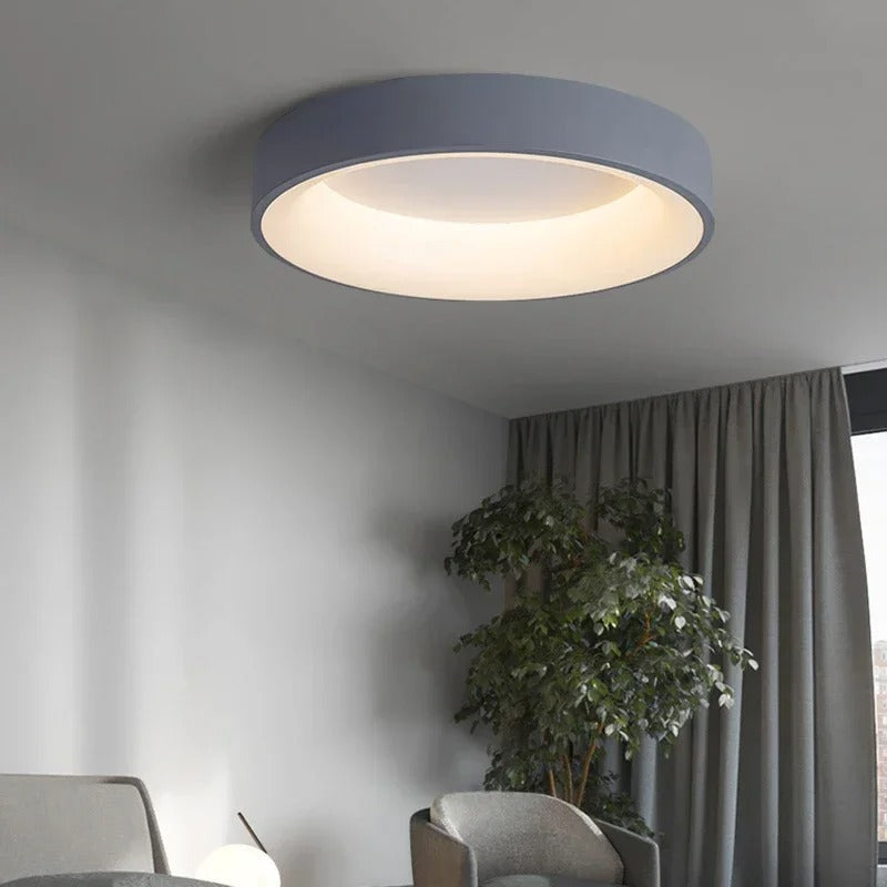 Modern circular LED ceiling light with sleek metal frame, soft ambient lighting; available in grey, white, wood finishes.