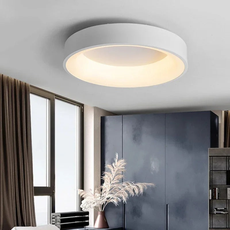 Modern circular LED ceiling light with sleek metal frame, soft ambient lighting; available in grey, white, wood finishes.