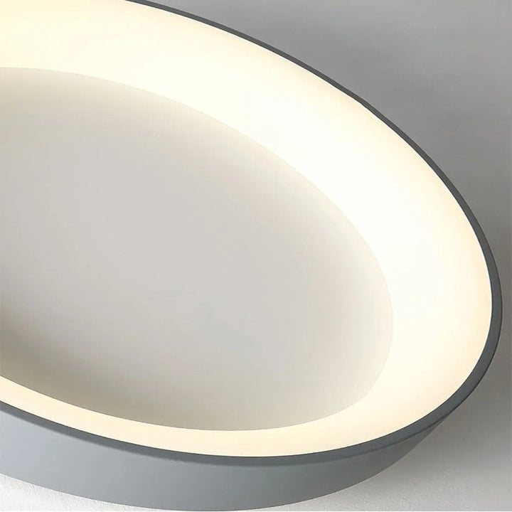 Modern circular LED ceiling light with sleek metal frame, soft ambient lighting; available in grey, white, wood finishes.