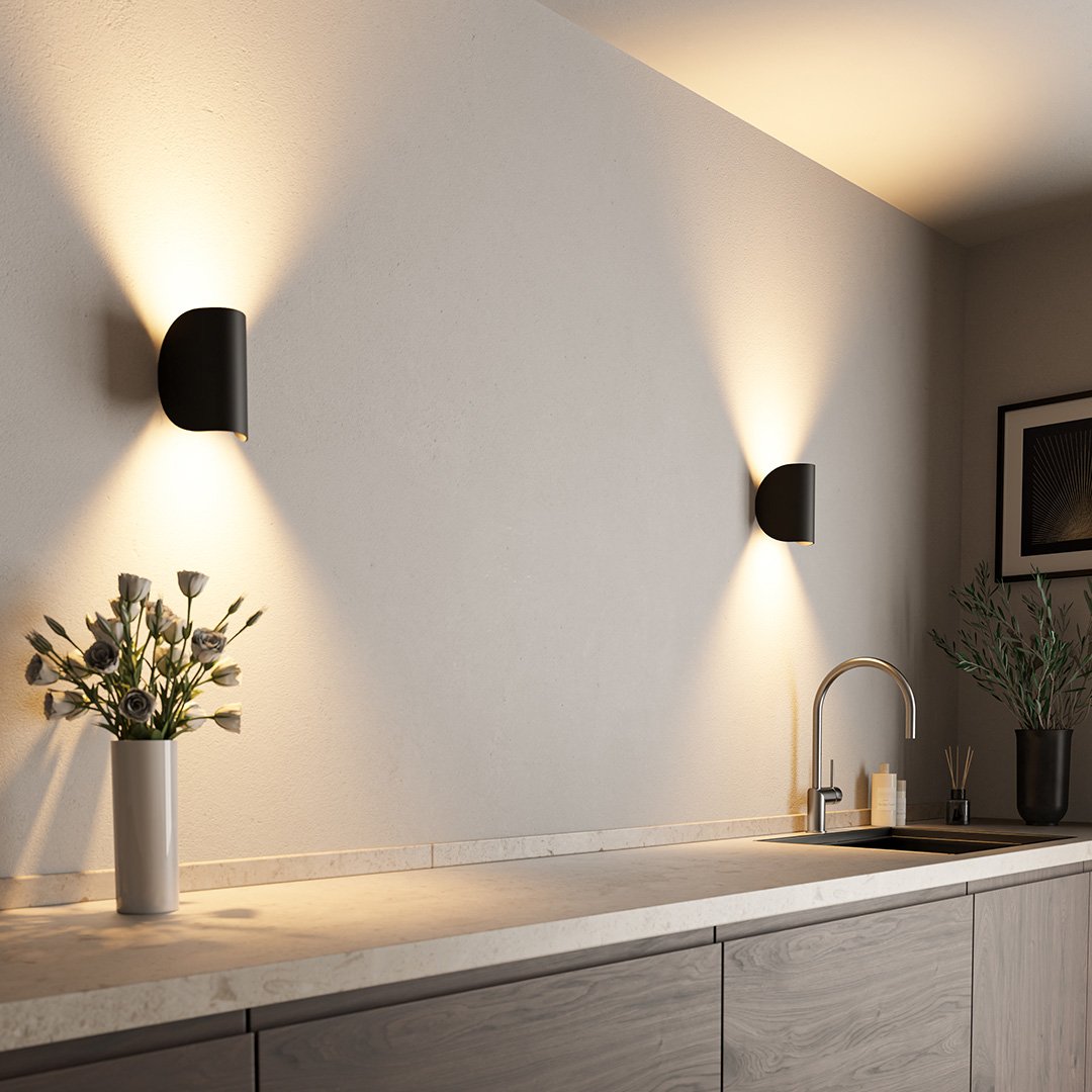 "Modern LED Up Down Wall Sconce Light, sleek black design, for indoor/outdoor use, illuminates spaces elegantly."