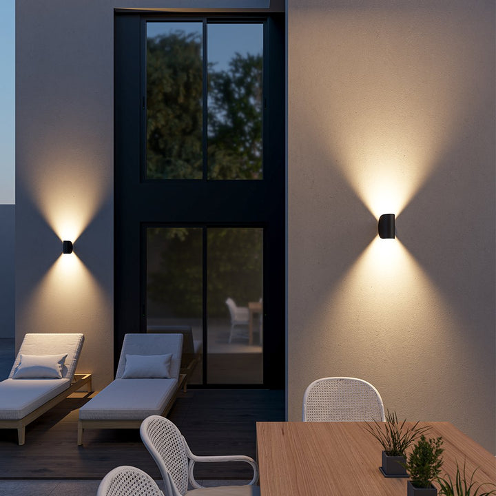 "Modern LED Up Down Wall Sconce Light, sleek black design, for indoor/outdoor use, illuminates spaces elegantly."