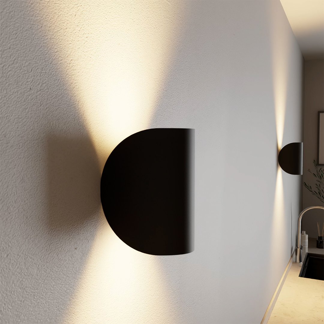 "Modern LED Up Down Wall Sconce Light, sleek black design, for indoor/outdoor use, illuminates spaces elegantly."