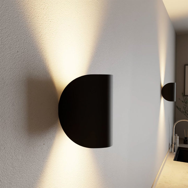 "Modern LED Up Down Wall Sconce Light, sleek black design, for indoor/outdoor use, illuminates spaces elegantly."