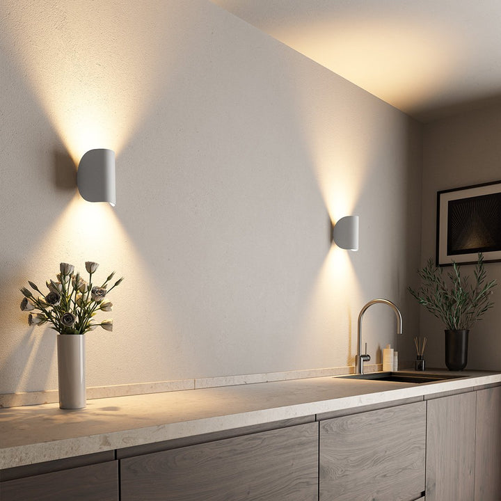 "Modern LED Up Down Wall Sconce Light, sleek black design, for indoor/outdoor use, illuminates spaces elegantly."