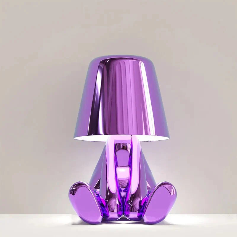 Modern metallic figurine table lamp featuring a 'Thinker' sculpture design, emits a warm LED glow, perfect for elegant decor.