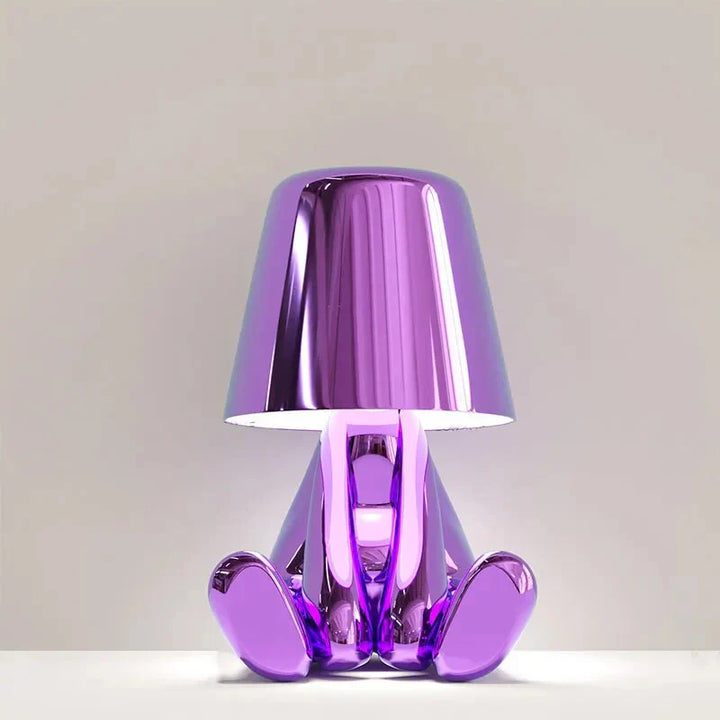 Modern metallic figurine table lamp featuring a 'Thinker' sculpture design, emits a warm LED glow, perfect for elegant decor.