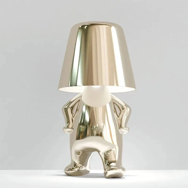 Modern metallic figurine table lamp featuring a 'Thinker' sculpture design, emits a warm LED glow, perfect for elegant decor.