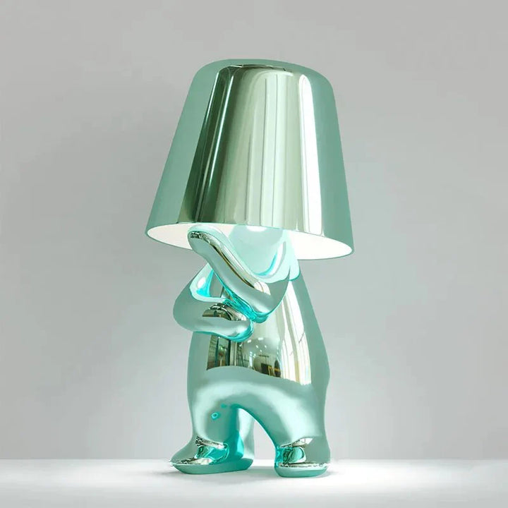 Modern metallic figurine table lamp featuring a 'Thinker' sculpture design, emits a warm LED glow, perfect for elegant decor.
