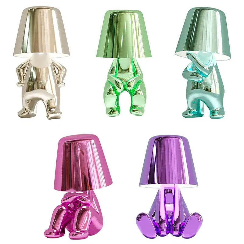 Modern metallic figurine table lamp featuring a 'Thinker' sculpture design, emits a warm LED glow, perfect for elegant decor.