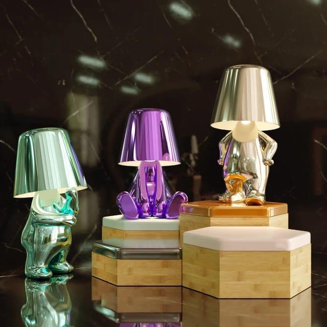 Modern metallic figurine table lamp featuring a 'Thinker' sculpture design, emits a warm LED glow, perfect for elegant decor.
